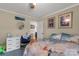 Cozy carpeted bedroom with ample natural light, a desk, and comfortable decor at 1162 E Doc Garris Rd, Lancaster, SC 29720