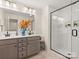 Modern bathroom featuring a dual sink vanity and large glass-enclosed shower at 12016 Basking Dr, Charlotte, NC 28214