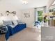 Bright bedroom featuring a comfortable daybed, a cozy chair, and a large window at 12016 Basking Dr, Charlotte, NC 28214