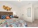 A well decorated bedroom featuring colorful bedding, and a wooden headboard at 12016 Basking Dr, Charlotte, NC 28214