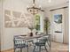 Beautiful dining room with modern chandelier and large window letting in plenty of natural light at 12016 Basking Dr, Charlotte, NC 28214