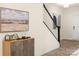 Inviting entryway featuring stylish cabinet and staircase with black railing and views into other rooms at 12016 Basking Dr, Charlotte, NC 28214