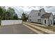 New construction townhomes with gray siding, a private gate and an inviting entrance at 12016 Basking Dr, Charlotte, NC 28214