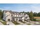 New townhomes featuring craftsman-style architecture, attached garages, and professional landscaping at 12016 Basking Dr, Charlotte, NC 28214