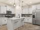 Bright and airy kitchen boasting white cabinetry, stainless steel appliances, and a center island at 12016 Basking Dr, Charlotte, NC 28214