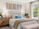 Bright main bedroom featuring stylish furnishings, a large window, and neutral tones at 12016 Basking Dr, Charlotte, NC 28214
