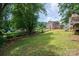 Backyard view featuring green lawn, a wood fence and landscaping at 1256 Canseco Ln, Hickory, NC 28602