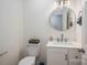 Bathroom featuring a modern vanity, toilet, and round mirror at 1256 Canseco Ln, Hickory, NC 28602