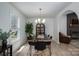 Inviting dining room featuring a rustic wooden table, modern chairs, and a large window for natural light at 1256 Canseco Ln, Hickory, NC 28602