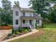 Two-story home with a charming porch and landscaped front yard, blending comfort with curb appeal at 1256 Canseco Ln, Hickory, NC 28602
