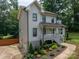 Two story home with attached two car garage and quaint front porch surrounded by beautiful landscaping at 1256 Canseco Ln, Hickory, NC 28602