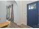 View of the foyer with a blue front door, coat closet, and wood flooring at 1256 Canseco Ln, Hickory, NC 28602