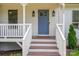 Inviting front entrance features a classic blue door, stylish sconces, and white-railed porch at 1256 Canseco Ln, Hickory, NC 28602