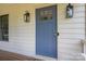 Close-up of a blue front door with window panes and stylish sconces, exuding classic charm at 1256 Canseco Ln, Hickory, NC 28602