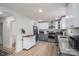 Renovated kitchen with stainless steel appliances, gray and white cabinets, marble backsplash, and wood flooring at 1256 Canseco Ln, Hickory, NC 28602