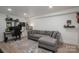Basement living room featuring a gray sofa, neutral flooring and ample space at 1256 Canseco Ln, Hickory, NC 28602