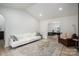 Bright living room with a white sofa, glass coffee tables, and an open layout leading to the dining area at 1256 Canseco Ln, Hickory, NC 28602