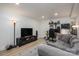 Basement living room featuring a gray sofa, tv, desk and neutral flooring at 1256 Canseco Ln, Hickory, NC 28602