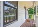 Cozy porch view featuring a blue front door, stylish light fixtures, and view of surrounding landscape at 1256 Canseco Ln, Hickory, NC 28602