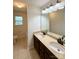 Bathroom featuring dual sinks with updated fixtures, vanity, and tile flooring at 1304 Ridge Haven Rd, Waxhaw, NC 28173