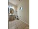 Bathroom featuring tile floor, pedestal sink, and round window at 1304 Ridge Haven Rd, Waxhaw, NC 28173
