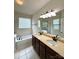 Bathroom with double vanity, large mirror, soaking tub, and glass shower at 1304 Ridge Haven Rd, Waxhaw, NC 28173