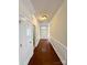 Inviting hallway with hardwood floors, wainscoting, and neutral paint, leading to a bright and airy living space at 1304 Ridge Haven Rd, Waxhaw, NC 28173