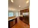 Spacious kitchen featuring stainless steel appliances, dark wood cabinets, and a clear view into the living area at 1304 Ridge Haven Rd, Waxhaw, NC 28173