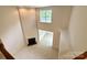 High angle view of living room featuring fireplace, window, and neutral carpet at 1304 Ridge Haven Rd, Waxhaw, NC 28173