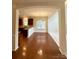 Open-concept living room with hardwood floors leading to the kitchen and carpet floors to sunroom at 1304 Ridge Haven Rd, Waxhaw, NC 28173