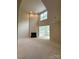 Bright and airy living room with a fireplace and views to the sunroom at 1304 Ridge Haven Rd, Waxhaw, NC 28173