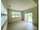 Bright sun room features tile floor, large windows, and sliding door to backyard at 1304 Ridge Haven Rd, Waxhaw, NC 28173