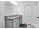 A well-lit bathroom features a double sink vanity with granite countertop at 13140 Sudwick Ln, Charlotte, NC 28278
