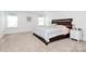 A bright bedroom features neutral walls, carpet, and a bed with white and gray linens at 13140 Sudwick Ln, Charlotte, NC 28278