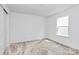 This bedroom has neutral carpet, white walls, and natural light from the window at 13140 Sudwick Ln, Charlotte, NC 28278