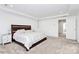 Spacious bedroom featuring plush carpeting, a tray ceiling, and natural light at 13140 Sudwick Ln, Charlotte, NC 28278