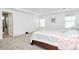 A bright bedroom features neutral walls, carpet, and a bed with white and pink linens at 13140 Sudwick Ln, Charlotte, NC 28278