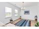Light-filled dining room with hardwood flooring, modern chandelier, and neutral decor at 13140 Sudwick Ln, Charlotte, NC 28278