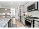 Modern kitchen features stainless steel appliances, granite countertops, and a gas range at 13140 Sudwick Ln, Charlotte, NC 28278
