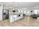 Bright, open kitchen with a large island, stainless steel appliances, and seamless flow to the living area at 13140 Sudwick Ln, Charlotte, NC 28278