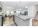 Open kitchen boasts a large island with granite countertops and stainless steel appliances at 13140 Sudwick Ln, Charlotte, NC 28278