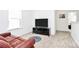 Bright living room featuring neutral carpet, a window, and entertainment center at 13140 Sudwick Ln, Charlotte, NC 28278