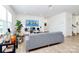 Bright living room with modern decor, plants, and a comfortable gray sofa at 13140 Sudwick Ln, Charlotte, NC 28278