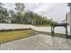 The backyard features a concrete patio, a pergola, grass and landscaping, all enclosed by a white privacy fence at 1323 Mifflin Ln, Dallas, NC 28034
