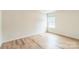 Well-lit bedroom features wood-look flooring and a bright window at 1323 Mifflin Ln, Dallas, NC 28034