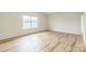 Sunny bedroom features wood-look floors and a large window at 1323 Mifflin Ln, Dallas, NC 28034