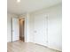This bedroom features neutral walls, light wood floors, and white doors for a clean, minimalist aesthetic at 1323 Mifflin Ln, Dallas, NC 28034