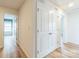 Hallway featuring wood-look floors, white walls and doors, and access to other rooms at 1323 Mifflin Ln, Dallas, NC 28034