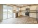 Bright kitchen featuring white cabinets, stainless steel appliances, granite countertops and sliding glass door to the back patio at 1323 Mifflin Ln, Dallas, NC 28034