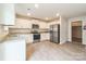 Modern kitchen with white cabinets, stainless steel appliances, granite countertops and wood-look floors at 1323 Mifflin Ln, Dallas, NC 28034
